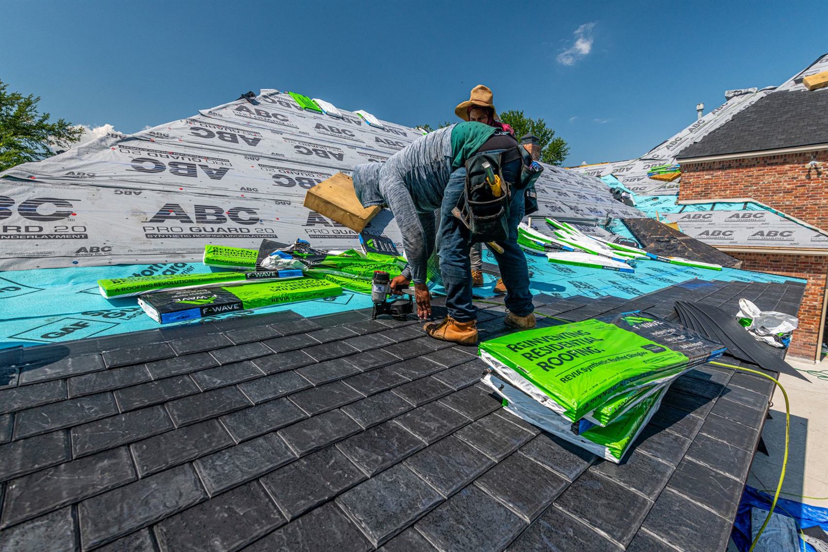 Roofer at work under a clear sky