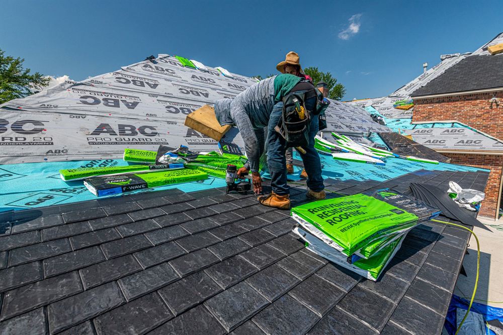 Roofer installing shingles